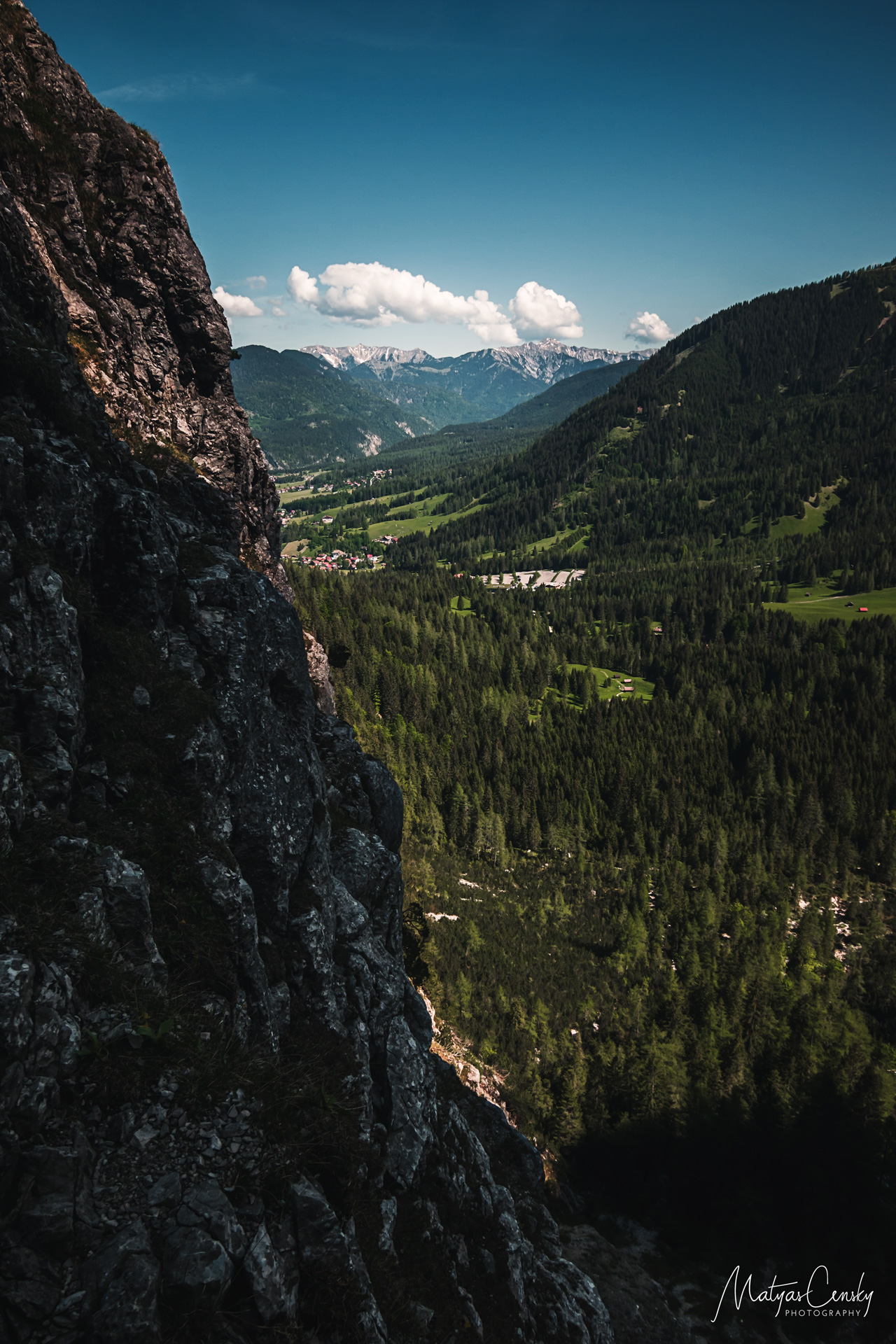 Photo of a valley under Seebener klettersteig with a rock on left side taken from a climbers view.
