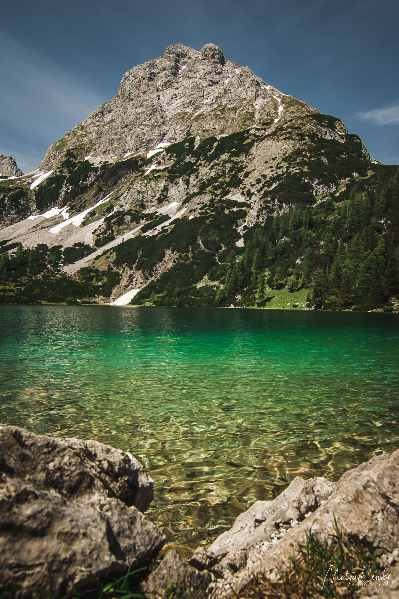Photo of mountain lake Seebensee, with Ehrwalder Sonnenspitze mountain in the background.