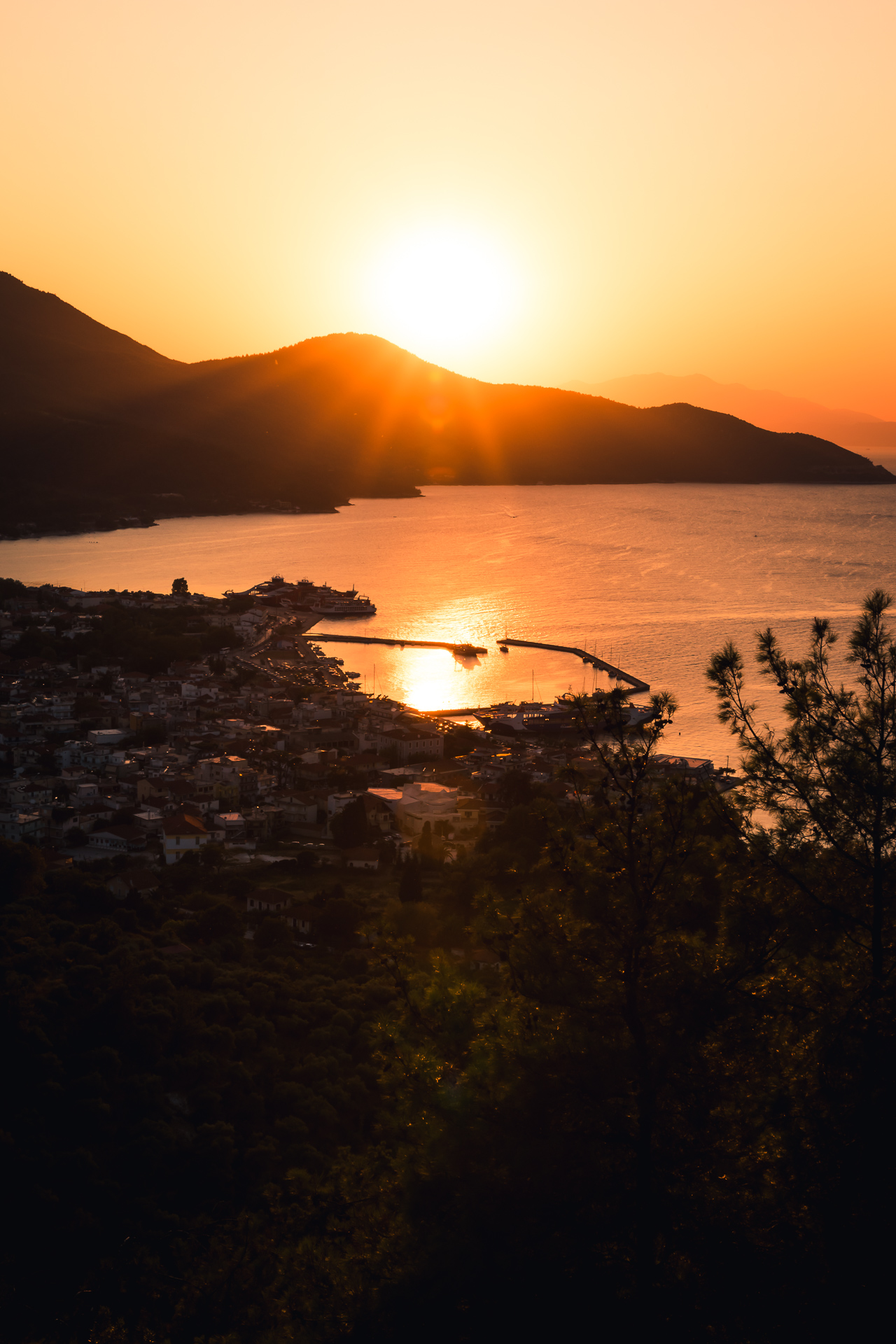 Photo of a sunset over a small town on Thassos, Greece.