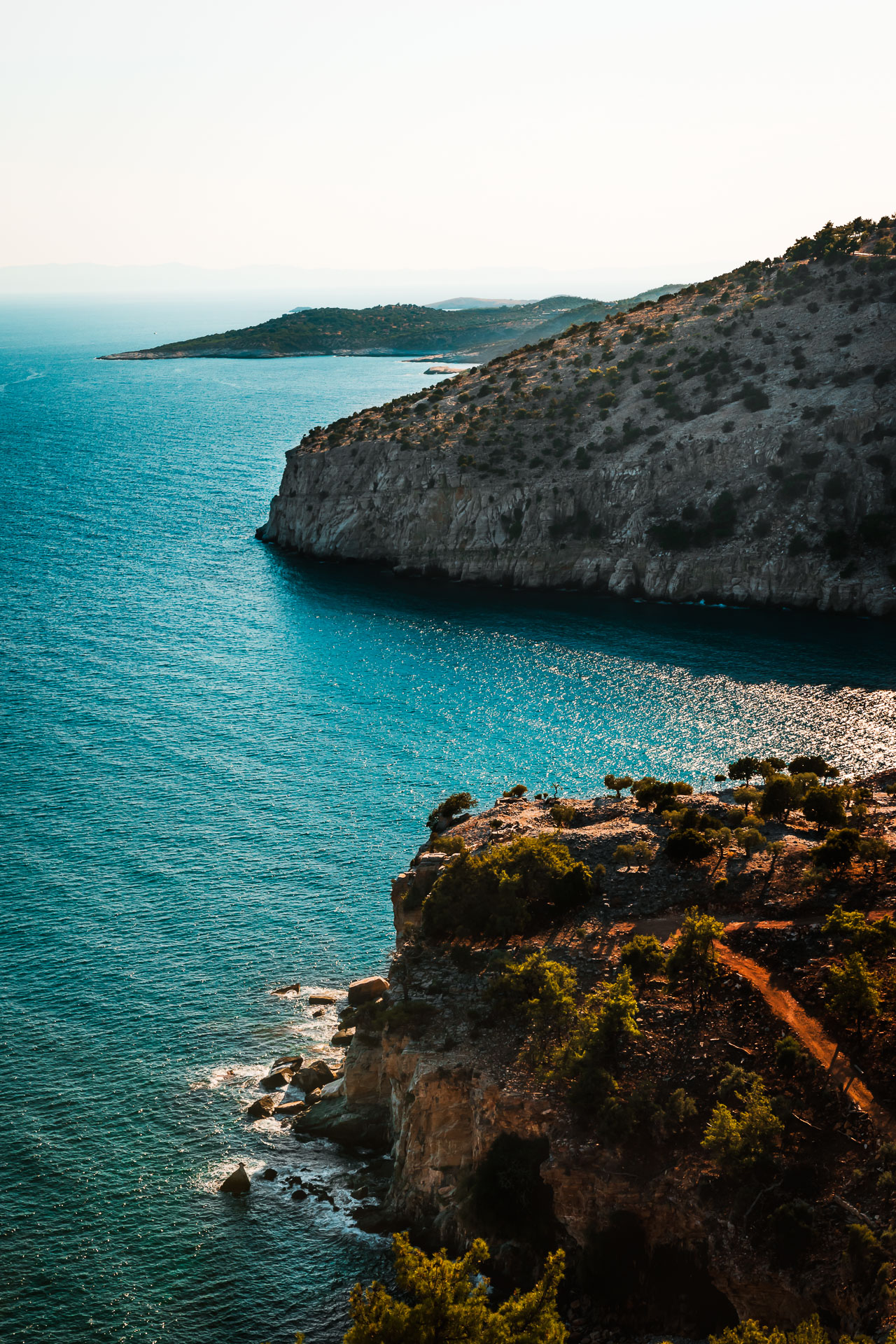 Photo of huge cliffs in Thassos, Greece with blue sea.
