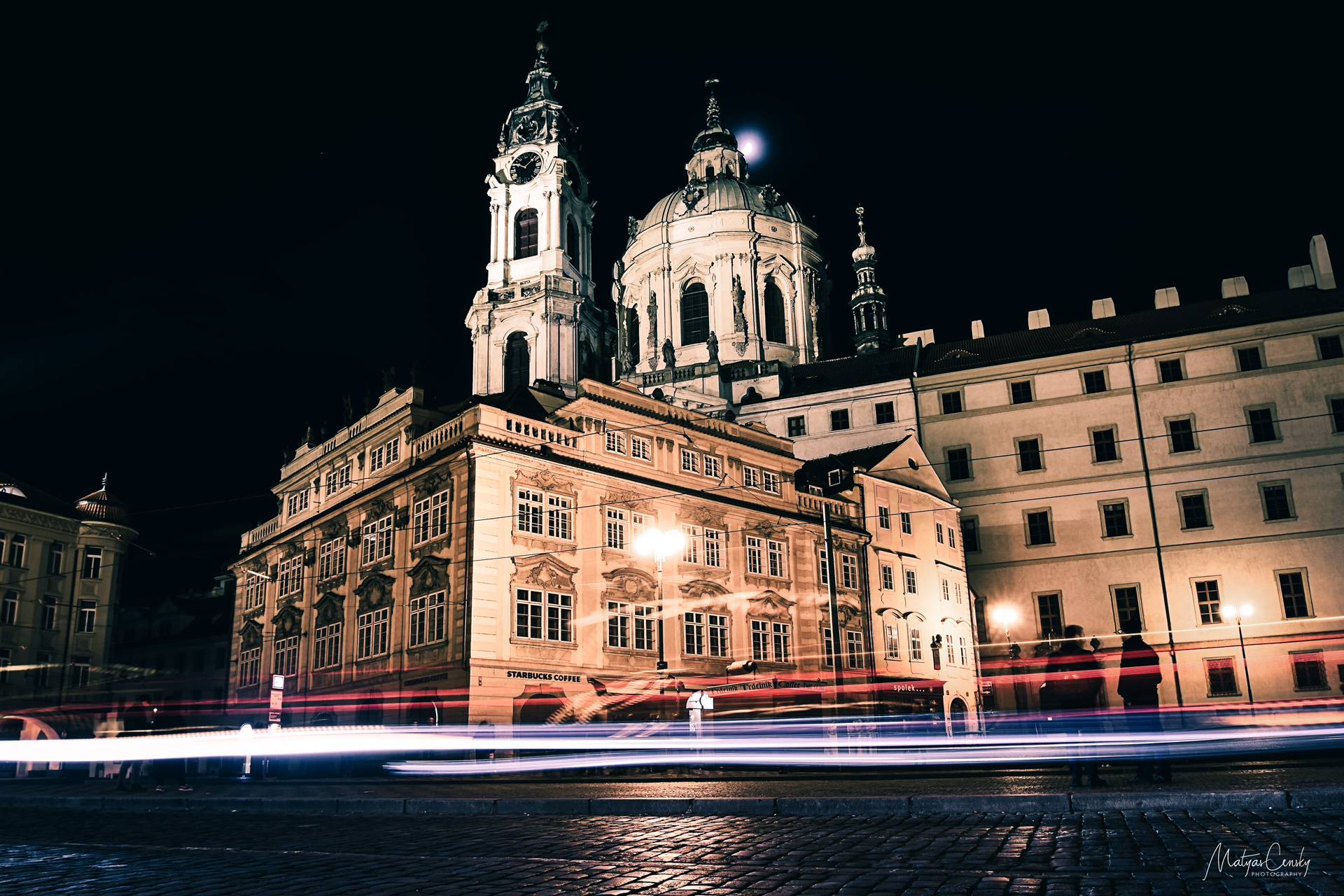 Long exposure shot of night city traffic in front of Malostranske namesti and St.Nicholas Church in Prague.