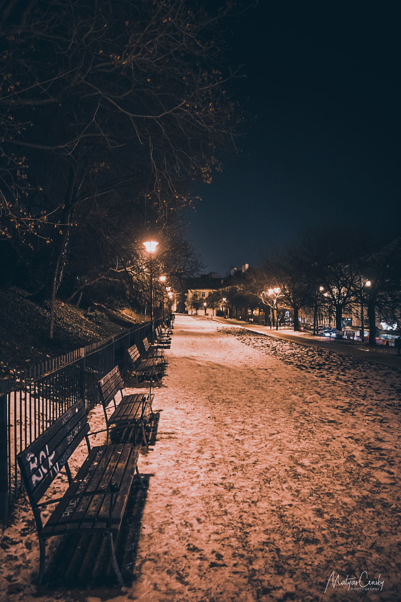 Photo of winter night park under Petrin on Ujezd tram stop in Prague.