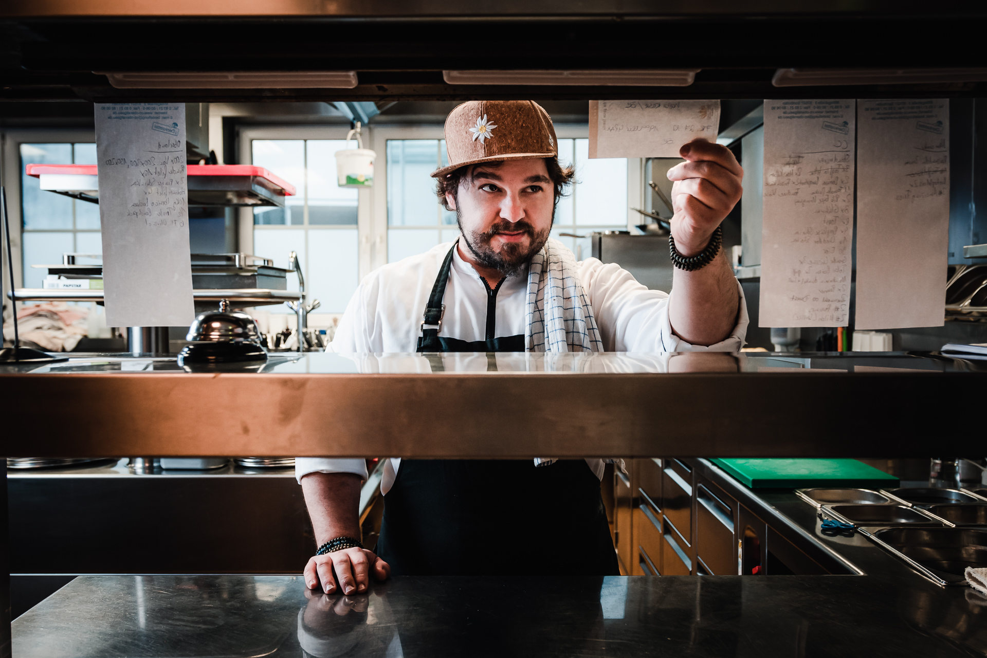 Portrait photo of a chef taking an order in the kitchen.
